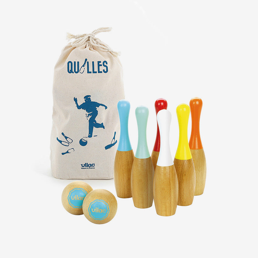 Colorful wooden bowling pins and balls with a branded bag on a white background